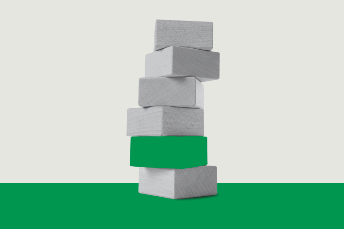 Stacked blocks with the green block stuck near the bottom