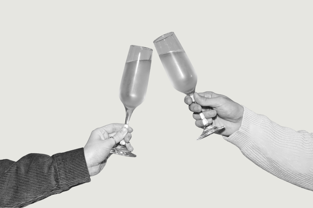 Two hands holding wine glasses