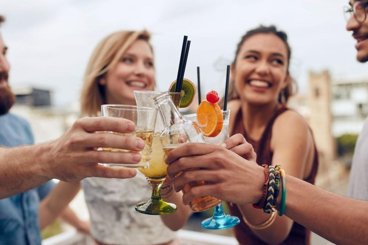 People having fun in groups and holding drinks for the party