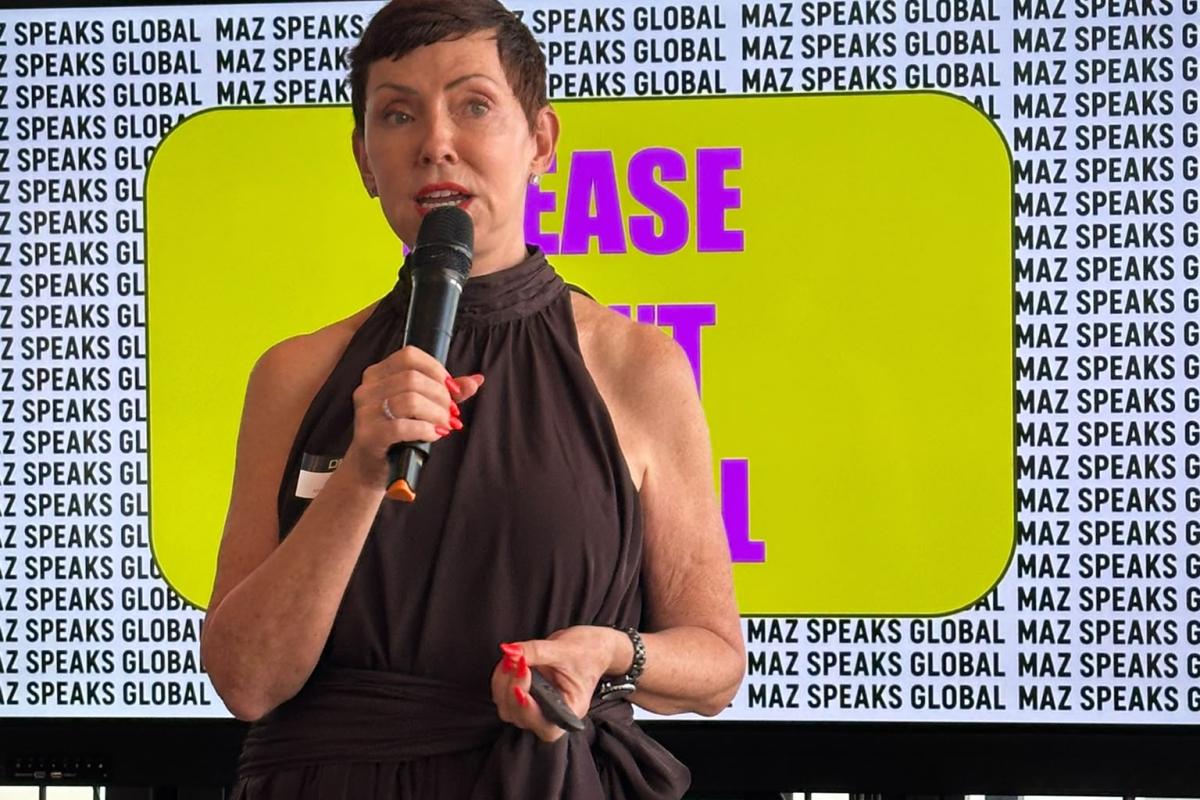 Maz Farrelly holding a mic in her session