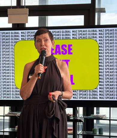 Maz Farrelly holding a mic in her session
